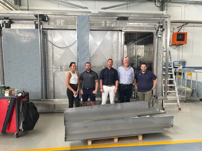 Group shot in front of autoclave at Steelco